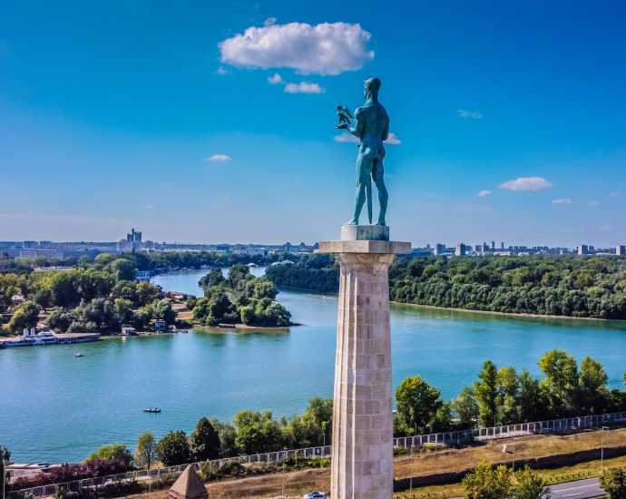 a statue of a man standing on top of a tower