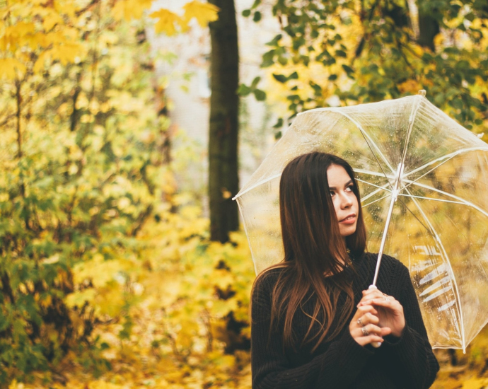 woman holding clear umbrella