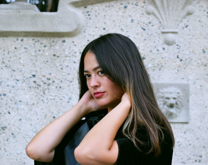 a woman in a black shirt is posing for a picture