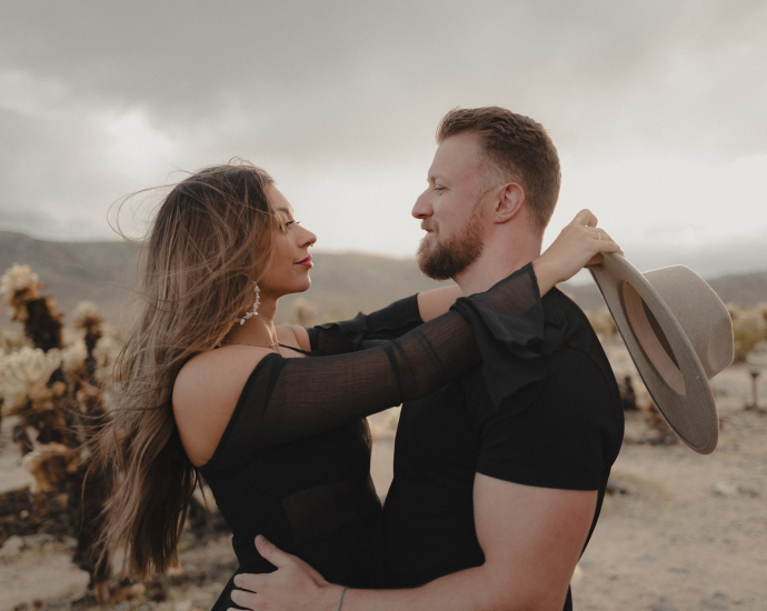 a man and a woman embracing in the desert