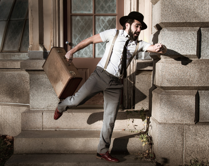 man in white dress shirt and gray pants sitting on gray concrete stairs