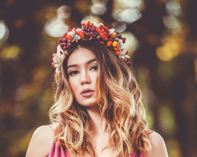 woman in pink V-neck sleeveless dress wearing flower crown in bokeh photography