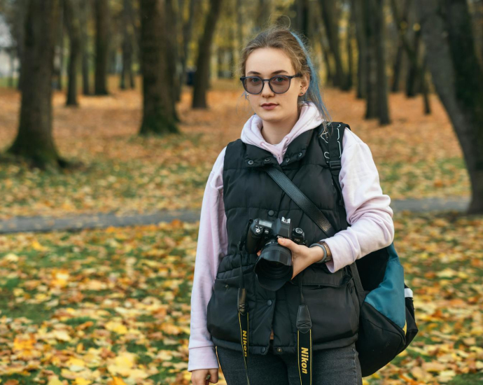 A woman with a camera in the park