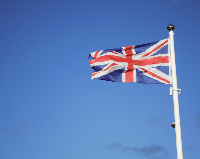 us a flag on pole under blue sky during daytime