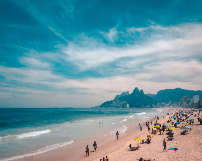 group of people sunbathing on beach