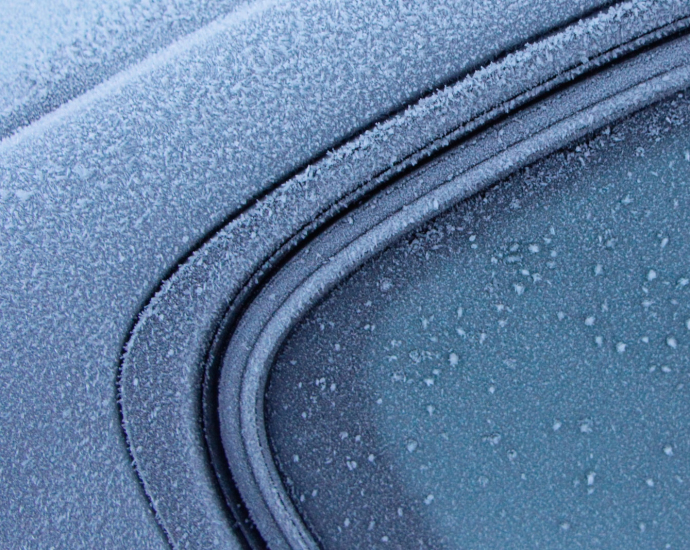 a close up of a car's windshield with drops of water on it