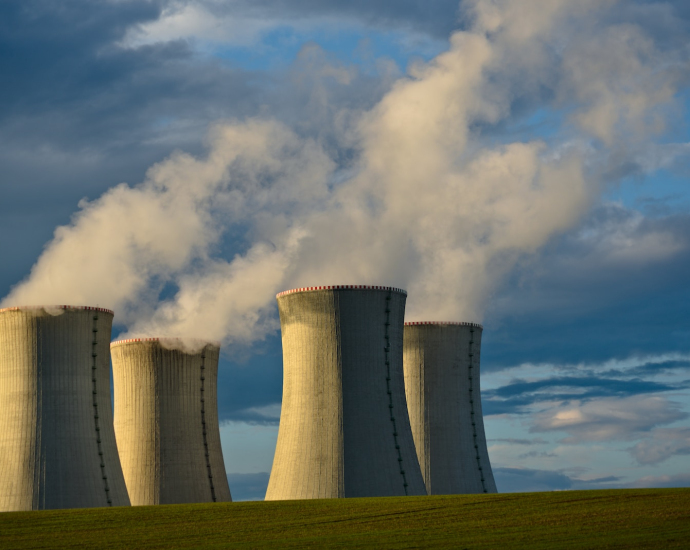 gray concrete towers under white clouds and blue sky during daytime