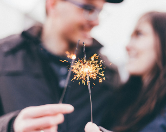 man and woman holding fireworks