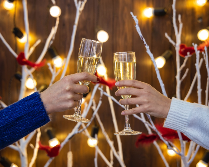 person holding wine glasses with red liquid