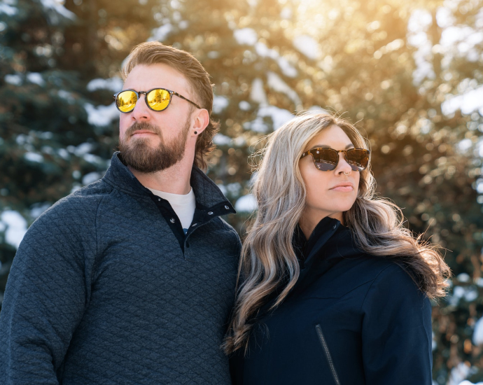 a man and a woman are standing in the snow