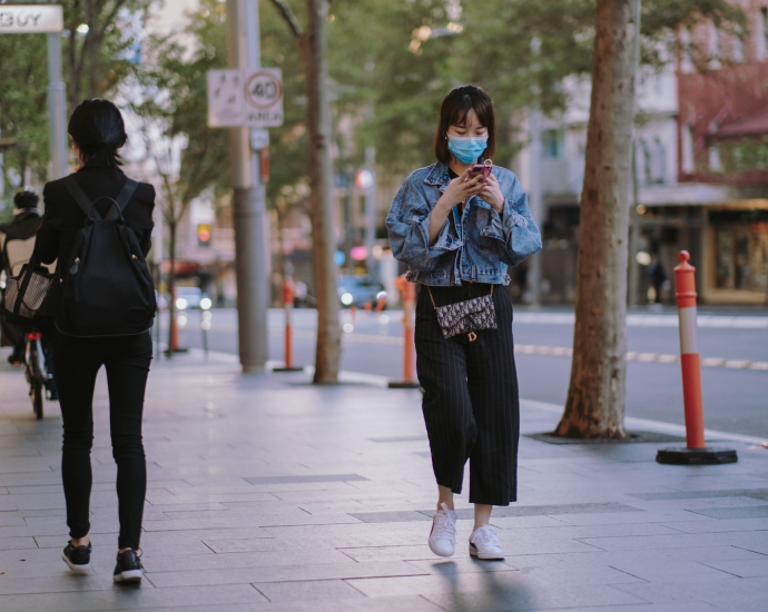 woman in black jacket and black pants standing on gray concrete floor during daytime