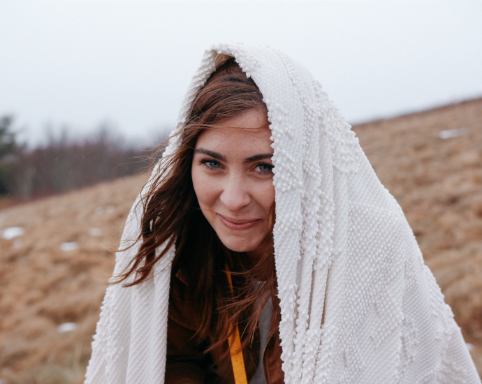 smiling woman wrapped with white headscarf