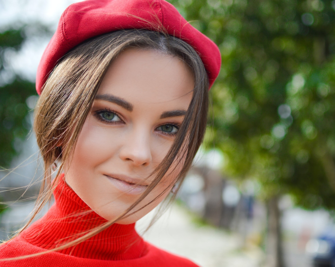 closeup photo of woman wearing red cap