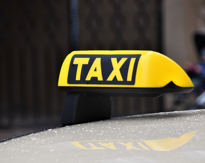 yellow and black taxi sign