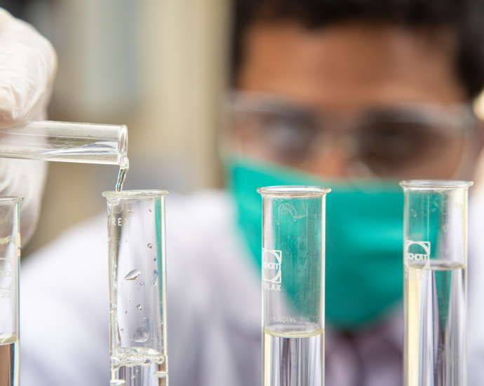 clear glass test tubes on blue plastic container