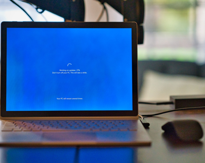 macbook pro on brown wooden table