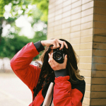 a woman taking a picture of herself with a camera