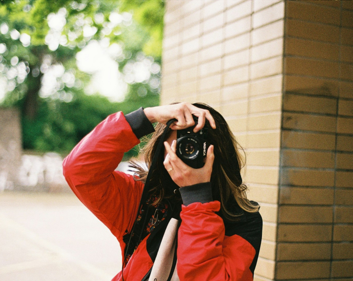 a woman taking a picture of herself with a camera