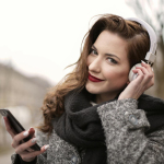 A Photo Of A Woman Listening To Music On White Headphones