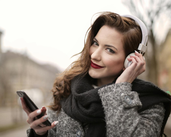 A Photo Of A Woman Listening To Music On White Headphones