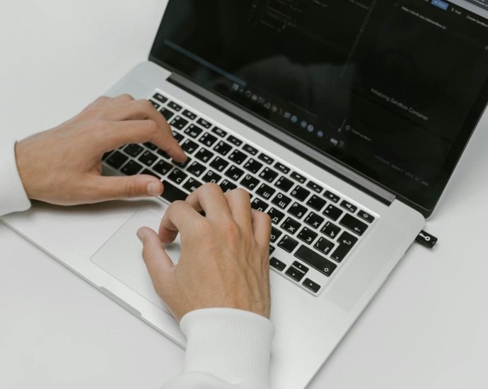 Hands on a Laptop Keyboard