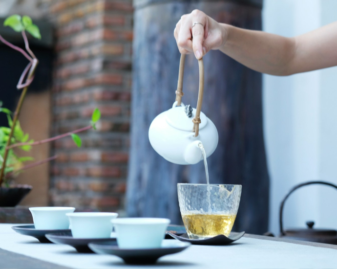 person holding kettle