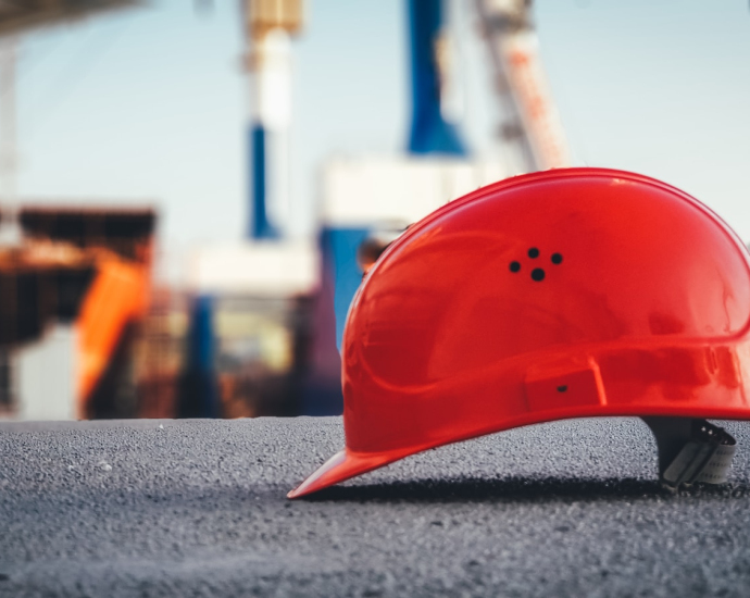 red hard hat on pavement