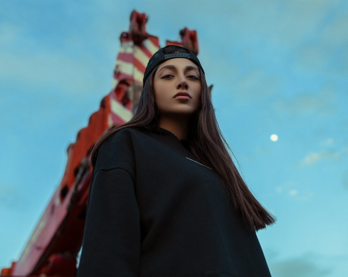 a woman standing in front of a carnival ride