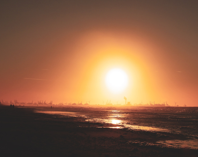 seashore under orange sky