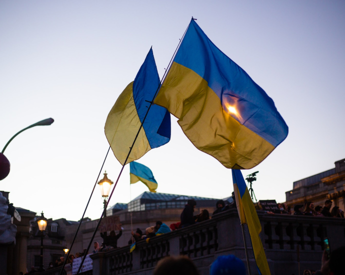 a group of people holding flags in front of a building