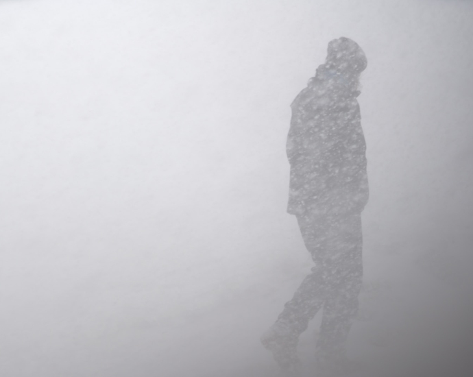 silhouette of man in snow storm