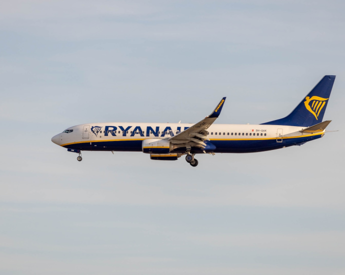 a large jetliner flying through a blue sky