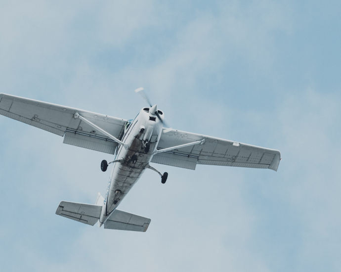 white airplane flying in the sky during daytime