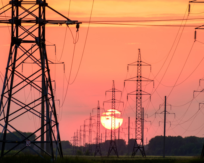 silhouette of electric post during sunset