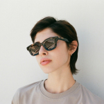 a woman wearing a pair of cat eye sunglasses