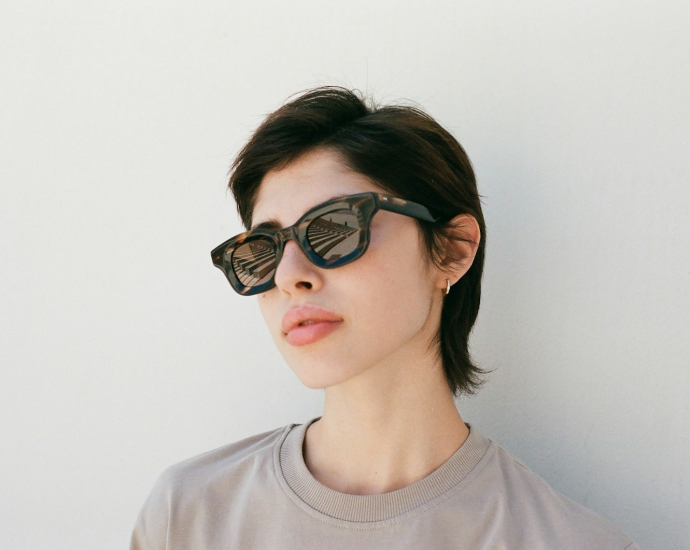 a woman wearing a pair of cat eye sunglasses