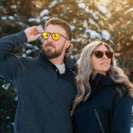 a man and a woman are standing in the snow