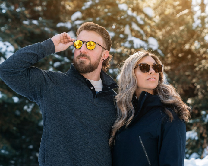 a man and a woman are standing in the snow