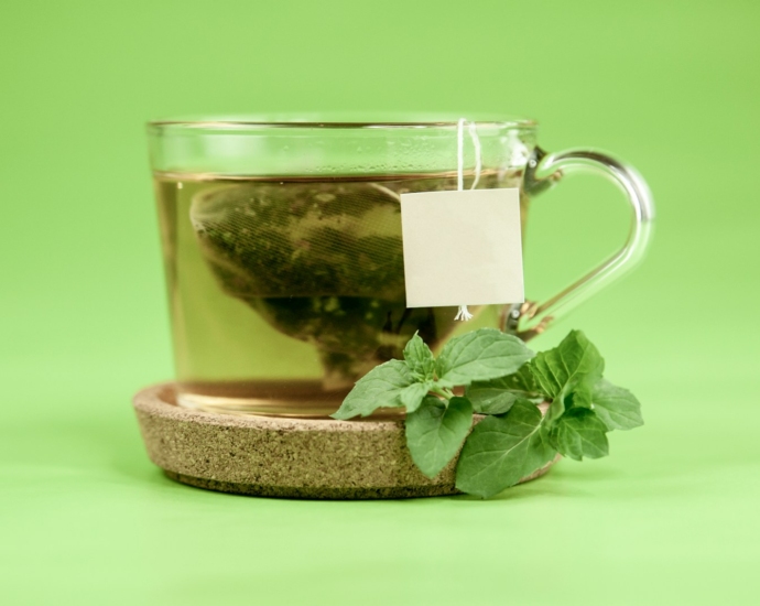 clear glass mug with green leaves