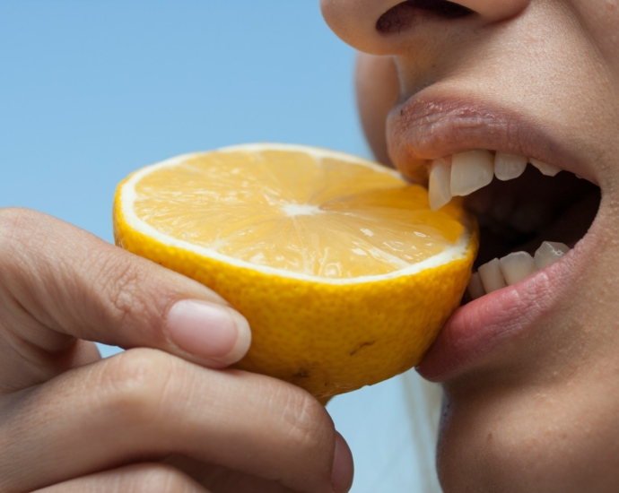 person holding orange fruit during daytime