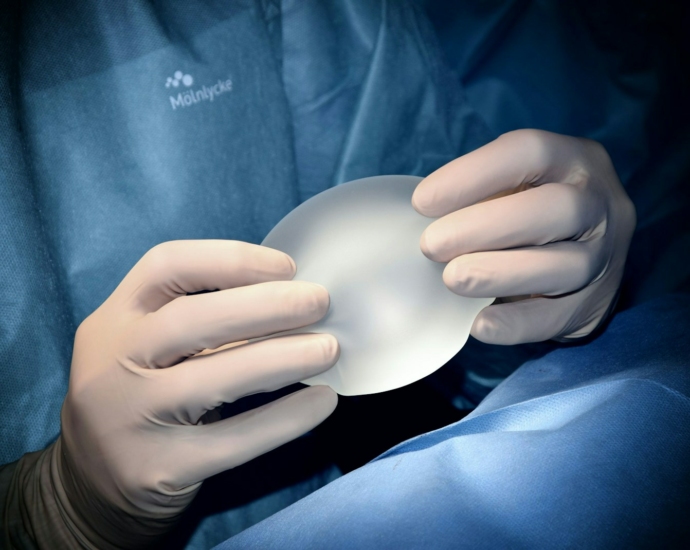 person holding white heart shaped ornament