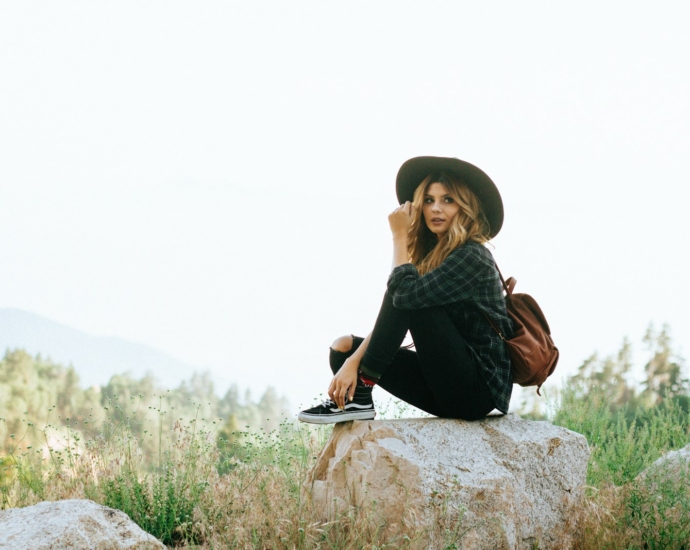 woman sitting on rock in forest