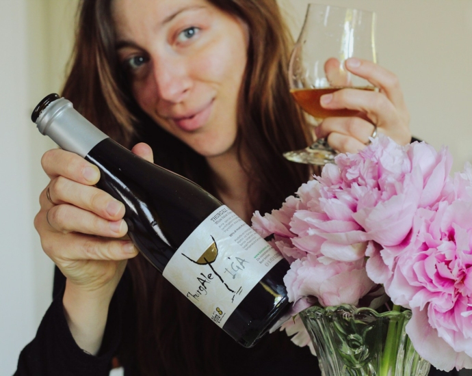 woman in black long sleeve shirt holding wine bottle