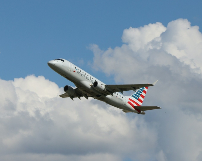 a large passenger jet flying through a cloudy blue sky