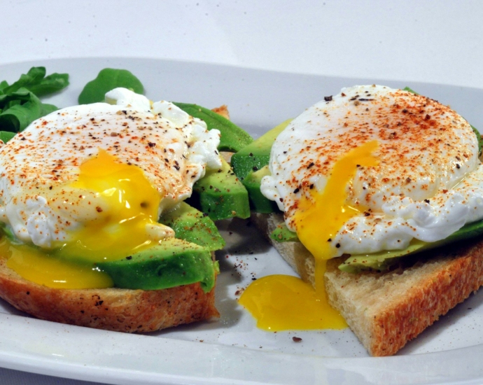 bread with egg and vegetable on white ceramic plate