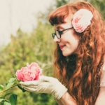 woman holding pink flower