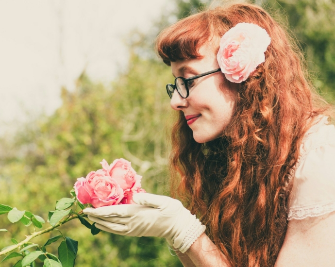 woman holding pink flower