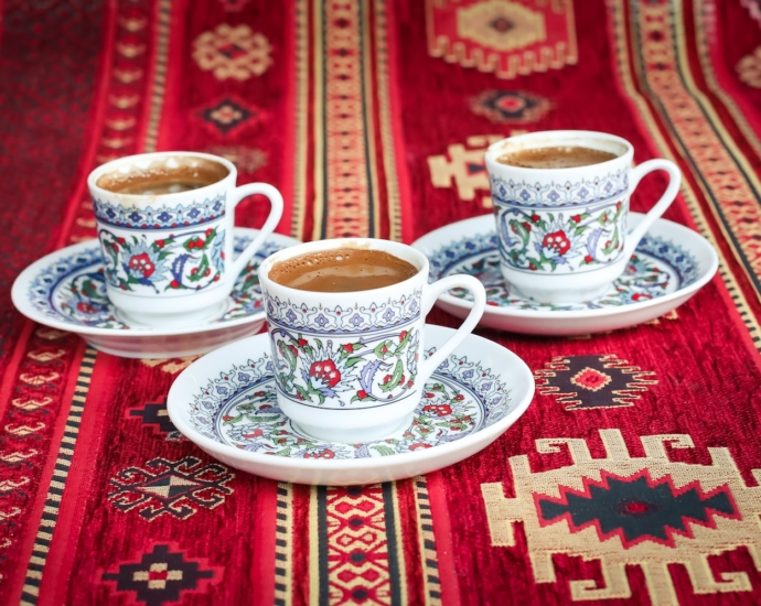 three multicolored floral ceramic cups and saucers