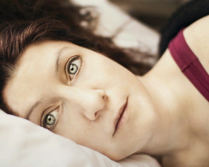 a close up of a person laying on a bed