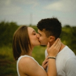 man in white tank top kissing woman in white tank top